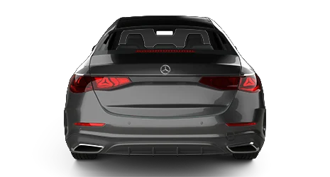 A black Mercedes-Benz sedan is shown from the rear, highlighting its modern taillights, chrome exhaust finishers, and a sleek trunk design